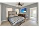 Cozy bedroom with a queen bed, TV, and access to other rooms at 506 Perkins St, Leesburg, FL 34748