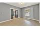 Inviting bedroom featuring sliding glass doors, soft window treatments, and stylish light fixture at 506 Perkins St, Leesburg, FL 34748