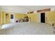 Spacious bonus room with tile flooring, yellow walls, and a white ceiling with exposed beams at 506 Perkins St, Leesburg, FL 34748