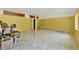 Spacious bonus room with yellow walls, tile flooring, and ample space for various activities at 506 Perkins St, Leesburg, FL 34748