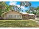 Charming single-story home with a well-maintained lawn and mature trees with Spanish moss at 506 Perkins St, Leesburg, FL 34748