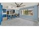 Bright eat-in kitchen features blue cabinets, marble countertops, tile flooring, and a large window at 506 Perkins St, Leesburg, FL 34748