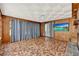 Retro-style living room featuring a brick fireplace, wood paneling, and a sliding glass door at 506 Perkins St, Leesburg, FL 34748