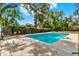 Backyard pool surrounded by mature trees and well-maintained landscaping at 506 Perkins St, Leesburg, FL 34748