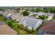 An aerial view of a well-maintained residential neighborhood and home with mature trees at 506 Weston Manor Dr, The Villages, FL 32162