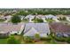 Residential neighborhood showcasing backyard, screened in porch, and meticulous landscaping at 506 Weston Manor Dr, The Villages, FL 32162