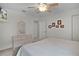Bedroom features a ceiling fan, carpet flooring, a dresser and an ensuite bathroom entrance at 506 Weston Manor Dr, The Villages, FL 32162