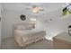 Bright bedroom featuring a ceiling fan, carpet flooring, a wreath decor, and natural light from the window at 506 Weston Manor Dr, The Villages, FL 32162