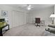 Cozy bedroom features plush carpeting, ample closet space, and a ceiling fan for added comfort and convenience at 506 Weston Manor Dr, The Villages, FL 32162
