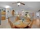 Open dining area featuring tile floors, a wooden table with seating, and access to the living room at 506 Weston Manor Dr, The Villages, FL 32162