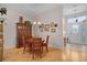 Cozy dining area with a wooden table set, chandelier lighting, and a view of the entryway at 506 Weston Manor Dr, The Villages, FL 32162