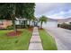 Charming home with well-maintained lawn, stepping stone path, and a variety of shrubbery and trees at 506 Weston Manor Dr, The Villages, FL 32162