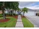 Welcoming home with lush lawn, walkway leading to a charming entrance at 506 Weston Manor Dr, The Villages, FL 32162