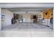 Spacious two-car garage with concrete floor, storage shelves, and ample room for vehicles and tools at 506 Weston Manor Dr, The Villages, FL 32162
