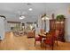 Open-concept living area featuring hardwood floors, skylights and views to the patio at 506 Weston Manor Dr, The Villages, FL 32162
