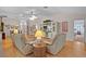 Spacious living room with hardwood floors, ceiling fan, and an open layout at 506 Weston Manor Dr, The Villages, FL 32162