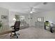 Comfortable living room with neutral carpet, ceiling fan, and gray wash dresser, creating a relaxing and stylish atmosphere at 506 Weston Manor Dr, The Villages, FL 32162