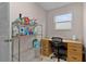 Practical home office space with ample shelving, a built-in desk, and a window providing natural light for productivity at 506 Weston Manor Dr, The Villages, FL 32162