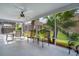 Relaxing screened-in patio with a ceiling fan and comfortable seating area at 506 Weston Manor Dr, The Villages, FL 32162