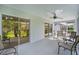 Screened patio offers backyard view, ample seating, and multiple sliding door entrances at 506 Weston Manor Dr, The Villages, FL 32162