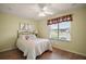 Comfortable bedroom with wood floors, a ceiling fan, and natural light at 507 Ventura Ct, The Villages, FL 32159