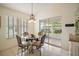 Bright dining area with a glass-top table and stylish chandelier at 507 Ventura Ct, The Villages, FL 32159