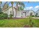 Charming single-Gathering home with beautiful palm trees and arched entryway, enhancing curb appeal at 507 Ventura Ct, The Villages, FL 32159
