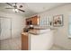 Kitchen with breakfast bar featuring wood cabinetry, stainless appliances, and tile flooring at 507 Ventura Ct, The Villages, FL 32159