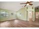 Spacious primary bedroom with vaulted ceilings, wood flooring, and abundant natural light at 507 Ventura Ct, The Villages, FL 32159