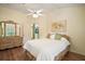Sunny main bedroom with a view of ensuite bathroom and wooden floors at 507 Ventura Ct, The Villages, FL 32159