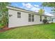 A view of the house's backyard featuring a well kept lawn and vinyl siding at 507 Ventura Ct, The Villages, FL 32159