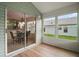 Cozy sunroom with wood floors, many windows, and glass sliding door at 507 Ventura Ct, The Villages, FL 32159