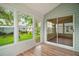 Cozy sunroom with wood floors and many windows overlooking the lawn at 507 Ventura Ct, The Villages, FL 32159