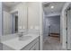 Modern bathroom with a white quartz vanity, white walls, and tile floors at 5354 Travertine St, Mount Dora, FL 32757
