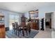 Dining room featuring a dark wood table, seating for four, and a large painting at 5354 Travertine St, Mount Dora, FL 32757
