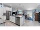 Open kitchen featuring an island with stainless steel appliances and easy access to the living room at 5354 Travertine St, Mount Dora, FL 32757
