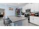 Kitchen with breakfast bar featuring stainless appliances, white cabinetry, and modern countertops at 5354 Travertine St, Mount Dora, FL 32757