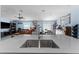 Kitchen island with a double sink overlooks the living room area with a ceiling fan at 5354 Travertine St, Mount Dora, FL 32757