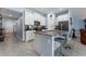 Bright kitchen features stainless appliances, white cabinets and a breakfast bar with seating at 5354 Travertine St, Mount Dora, FL 32757