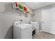 Functional laundry room with washer, dryer, and storage shelf at 5354 Travertine St, Mount Dora, FL 32757