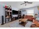 Spacious living room with tile floors, ceiling fan, and entertainment center at 5354 Travertine St, Mount Dora, FL 32757