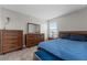 Inviting bedroom featuring neutral walls, coordinated furniture, and a comfortable bed at 5354 Travertine St, Mount Dora, FL 32757
