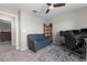 Cozy office space with a blue sofa, desk, and bookshelf for storage at 5354 Travertine St, Mount Dora, FL 32757