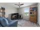Bright office featuring a ceiling fan, desk, chair, sofa, and a bookshelf at 5354 Travertine St, Mount Dora, FL 32757