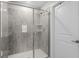 Tiled shower with a glass door, built-in shelving, and modern fixtures, providing a luxurious and practical space at 5354 Travertine St, Mount Dora, FL 32757
