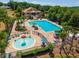 A community pool area offers a splash fountain, lounge chairs, and shady umbrellas at 5354 Travertine St, Mount Dora, FL 32757