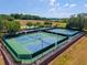 Aerial view of well-maintained tennis courts showcasing the community's recreational facilities at 5354 Travertine St, Mount Dora, FL 32757