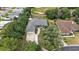 Aerial view displays well-kept lawn, mature trees, and meticulously maintained landscaping, creating a tranquil residential setting at 562 Dowling Cir, Lady Lake, FL 32159