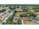 From above, discover a residential neighborhood that features a golf course as one of its attractive amenities at 562 Dowling Cir, Lady Lake, FL 32159
