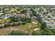 Neighborhood aerial view highlights mature trees, manicured lawns, and proximity to a golf course at 562 Dowling Cir, Lady Lake, FL 32159